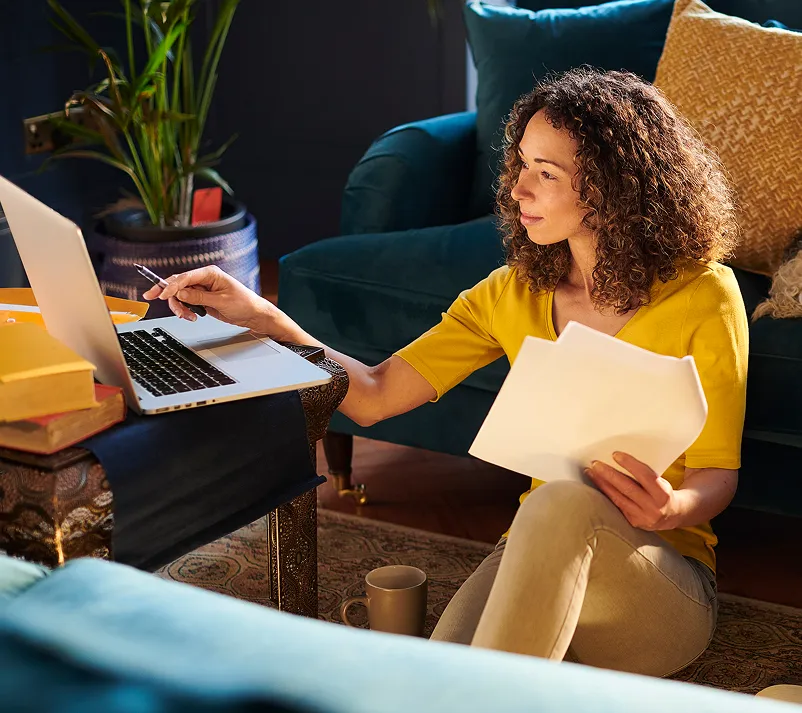Woman sitting at a laptop on a desk