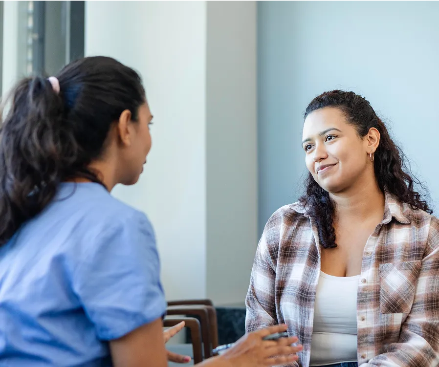 Two women talking in a healthcare setting
