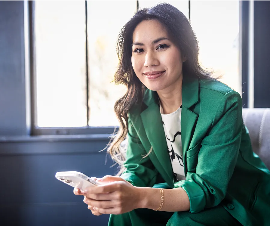 Young woman sitting in a chair holding a cell phone