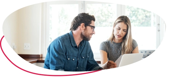 A man and a woman sitting with a laptop at a desk